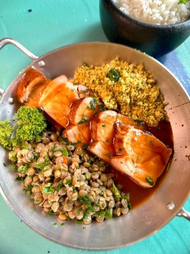 a plate of food with chicken and beans and rice at Pousada dos Gravatás in Búzios