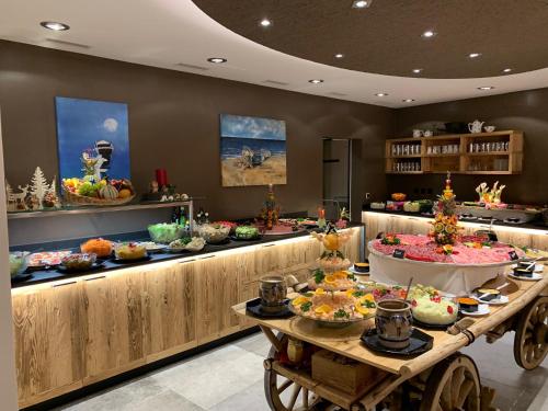 a buffet line with many different types of food at Hotel Spöl Restaurant in Zernez