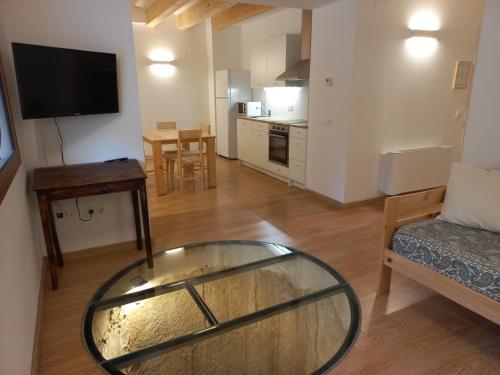 a living room with a glass table and a couch at Cal Vallverdú - Adaptado in Preixana
