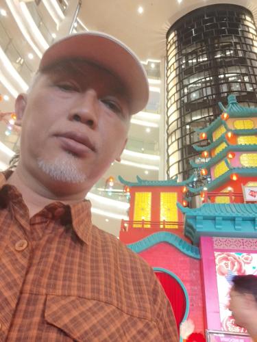 a man wearing a hat in a mall at Home 