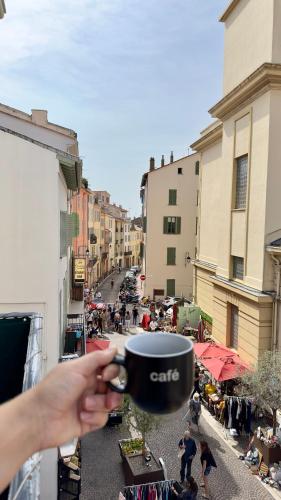 a person holding a cup in their hand at L'échelle Rouge in Cannes