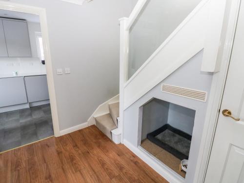a living room with a fireplace in the stairway at 12 Clos Yr Wylan in Barry