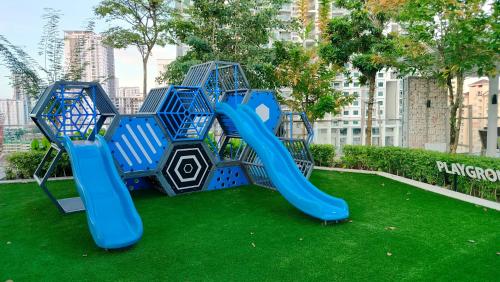 a playground with a slide on the grass at Ocean Home@Urban Suites@12 Pax in Jelutong
