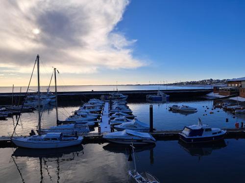 a group of boats are docked in a harbor at Beach 100m - Sea View - Log Burner - Dogs Welcome in Bessingby