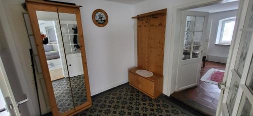 a hallway with a door and a mirror and a room at Ferienwohnungen Heinrichsberger in Bad Aibling
