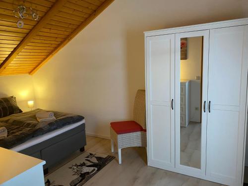a bedroom with a bed and a closet at Ferienwohnung Fischer in Rödental in Rödental