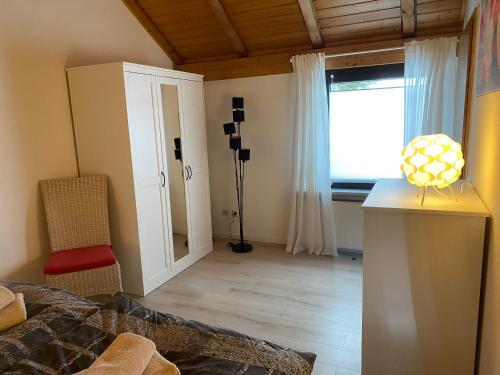 a living room with a bed and a window at Ferienwohnung Fischer in Rödental in Rödental
