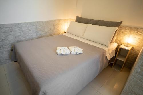 a bedroom with a bed with two towels on it at La Casa di Saretta in Terlizzi