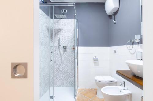 a bathroom with a shower and a toilet and a sink at Cagliari Old Town B&B in Cagliari