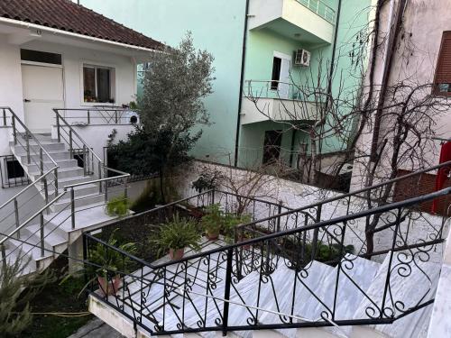 an external view of a building with stairs and plants at Ibras House in Durrës
