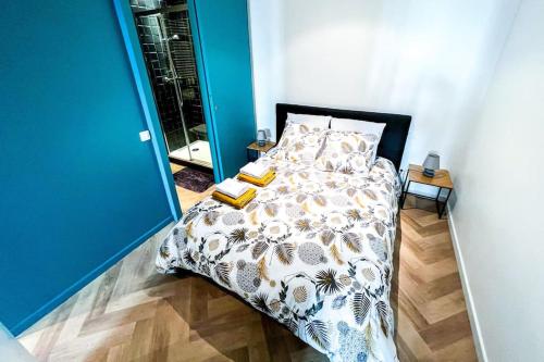 a bedroom with a bed with a comforter and two books at Modern Loft at the heart of life in Avignon
