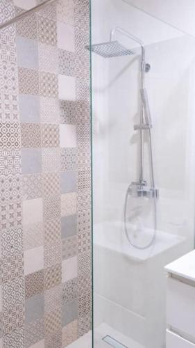 a shower with a glass door in a bathroom at Ana Lux Master apartament in Podgorica