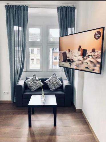 a living room with a couch and a table at Ring Home Stay in Adenau