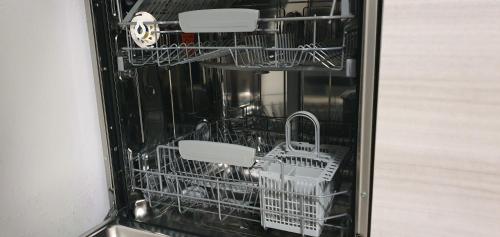 - un lave-vaisselle avec des plats blancs et des paniers dans l'établissement Beautiful Menton apartment Les Sablettes, à Menton