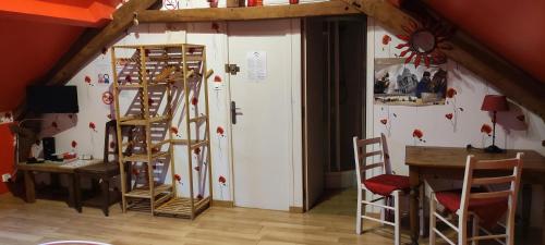 a room with a wall with several wooden ladders at Les Chambres du Relais in Liettres