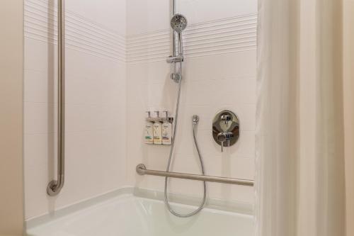 a shower in a bathroom with a tub at Candlewood Suites Collingwood, an IHG Hotel in Collingwood