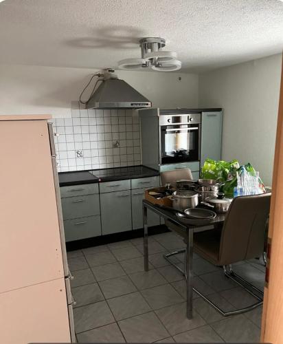 a kitchen with a table with pots and pans on it at Ganzes Haus in der Natur in Lauingen