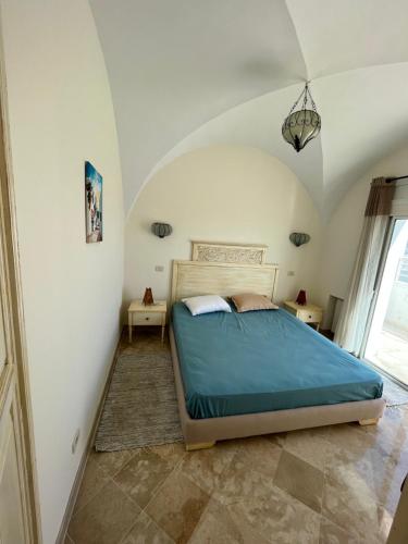 a bedroom with a bed and two night stands at DAR ELHOUCINE in Hammamet