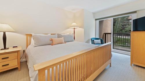 a bedroom with a large bed and a large window at Chalet Fescue in Vail