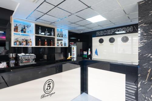 a bar with a counter with alcohol on it at Hotel Boutique 5 - Free parking - Free breakfast - Free internet - EVSE in Sofia