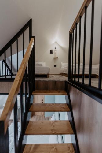 a stairway leading to a room with a bed at To Je To apartamenty in Maniowy