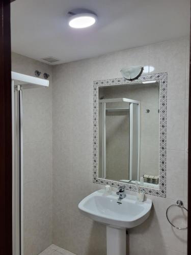 a bathroom with a sink and a mirror at Hostal La Frontera in Ferrol