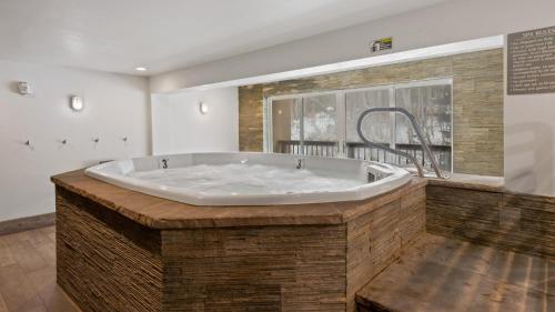 a large bath tub in a room with a window at Alpinewood Chalet in Vail