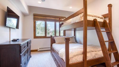 a bedroom with two bunk beds and a dresser at Icegrass Chalet in Edwards