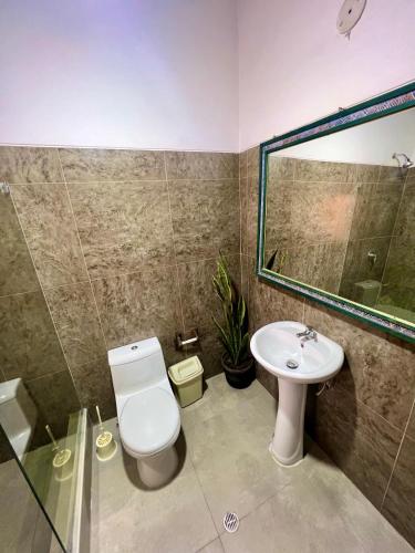 a bathroom with a toilet and a sink at Inka Tambo Hacienda in Cusco