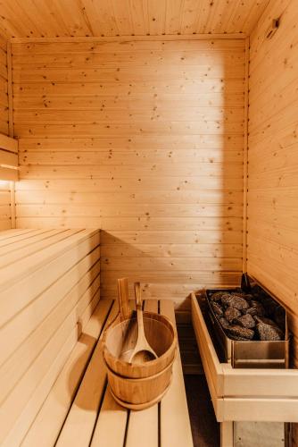 a wooden sauna with a wooden tub in it at To Je To apartamenty in Maniowy