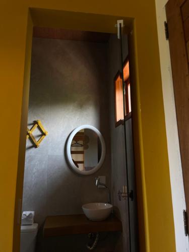 a bathroom with a sink and a mirror at Oka Pousada Atins in Atins