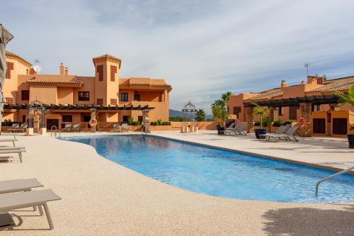 a swimming pool in front of a house at Royal Marbella Golf Resort in Estepona