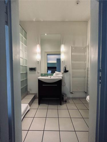 a bathroom with a sink and a mirror at Hotel BRASSERIE in Erlangen