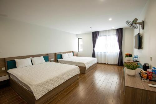 Ένα ή περισσότερα κρεβάτια σε δωμάτιο στο ANH TU Hotel