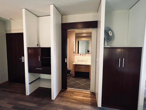 a bathroom with a sink and a mirror at Hotel BRASSERIE in Erlangen