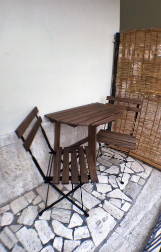 a wooden picnic table and a bench on a stone floor at Chianciano Lettings in Chianciano Terme