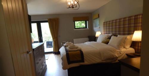 A bed or beds in a room at Bluebell Lodge