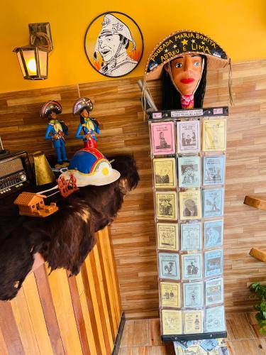 a room with a wall filled with stickers and aumedumed dog at Pousada Maria Bonita Abreu e Lima in Maricota