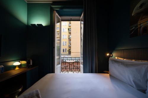 a bedroom with a bed and a view of a building at Fontana 16 Rooms in Milan