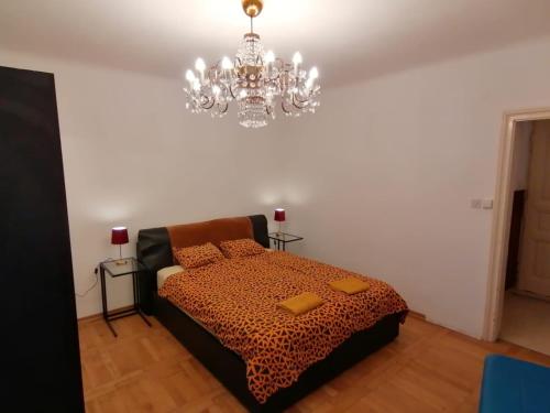 a bedroom with a bed and a chandelier at ZAGREB Botanical Garden Budget Apartment in Zagreb