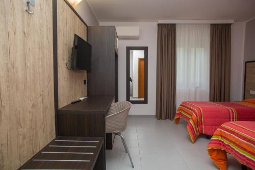 a hotel room with a desk and a bed at Hotel San Marco in Rionero in Vulture