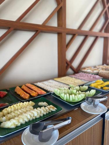 a buffet with many different types of food on plates at Makia Beach Experience By All in Porto De Galinhas