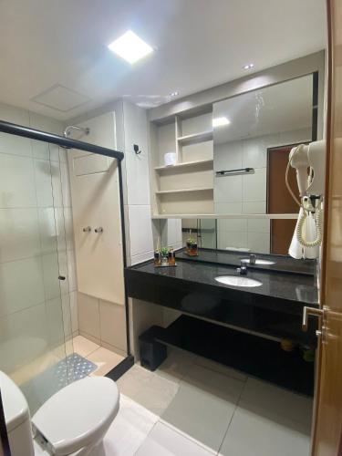 a bathroom with a sink and a shower and a toilet at Makia Beach Experience By All in Porto De Galinhas