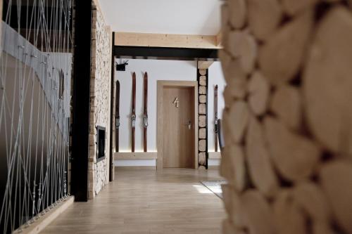 a hallway with a row of skis on the wall at Villa 11 Folk & Design in Zakopane