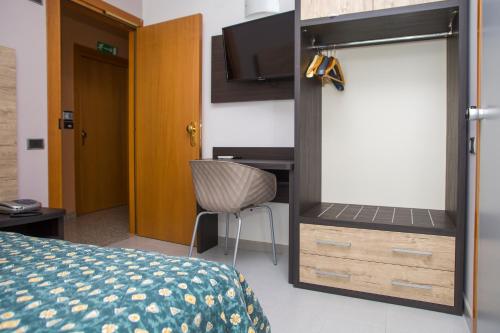 a bedroom with a bed and a desk and a chair at Hotel San Marco in Rionero in Vulture