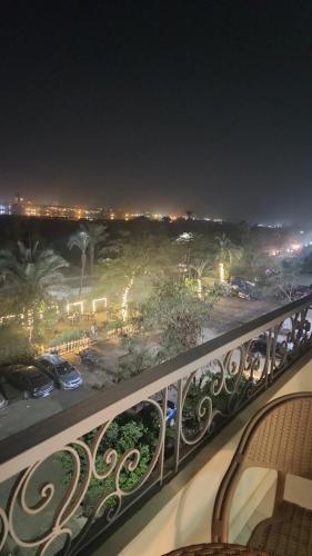 a balcony with a view of a parking lot at night at القاهره ركن حلوان شارع الشهيد in ‘Ezbet el-Auqât