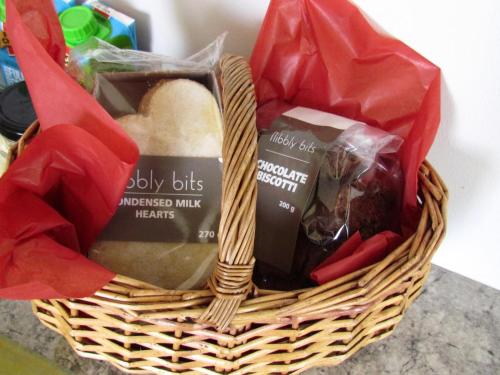 a basket filled with different types of bread at 80 on Rodger in Linkside