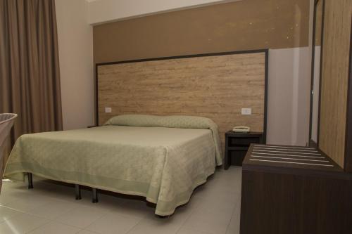 a bedroom with a bed and a large headboard at Hotel San Marco in Rionero in Vulture