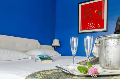 a bedroom with a bed with two champagne glasses at Grande Albergo Potenza in Potenza