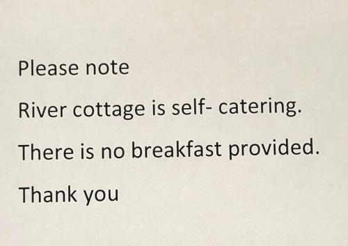a sign that reads please note river cottage is self catering there is no breakfast at Woodlands in Windermere